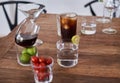 Glasses on a wooden table with cherry iced coffee