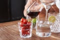 Glasses on a wooden table with cherry iced coffee