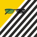 Glasses on the yellow and black white striped background. Flat lay Royalty Free Stock Photo
