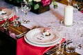 Glassware and cutlery for event dinner. Festive table with plates forks, knives, glasses, napkins and candle. Restaurant or cafe t Royalty Free Stock Photo