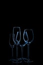 Glassware selection with wine, champagne and liquour glasses toned in classic blue on the dark background