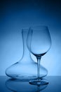 Glassware selection with wine glass and decanter on classic blue background