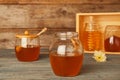 Glassware with tasty honey on table
