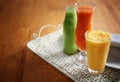 Glassware of tasty smoothies on wooden table