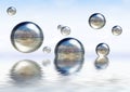 Glassy spheres floating on the water Royalty Free Stock Photo