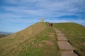 Glastonbury Somerset historic tor landmark with hill and path and people