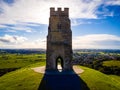 Glastonbury Tor near Glastonbury in the English county of Somerset, topped by the roofless St Michael`s Tower