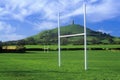 Glastonbury Tor, A sacred site along the English countryside in Glastonbury, England and goal posts in green field Royalty Free Stock Photo