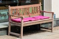 Glauchau, Germany - May 26, 2023: Wooden bench at a street side with the word Kurzurlaub (Short Vacation