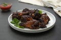 Glazed bbq chicken legs, drumsticks on plate, isolated Royalty Free Stock Photo