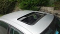 Glazed black hatch - sliding sedan car pavilion sunroof, beige leather interior, metallic paint, aerial view,