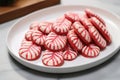 glazed candy cane-shaped cookies on a white plate Royalty Free Stock Photo