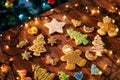 Glazed cookies lie on the table among luminous garlands. Top view