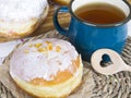 Glazed donuts and mug of tea