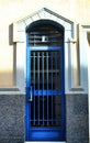 Glazed door with blue wrought iron details