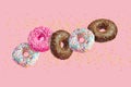 Glazed doughnuts in motion falling on pink background with colorful sprinkles Royalty Free Stock Photo