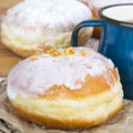 Glazed dounut and mug of tea