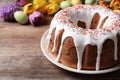 Glazed Easter cake with sprinkles on wooden table, closeup. Space for text Royalty Free Stock Photo