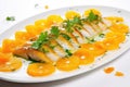 glazed fish fillet with citrus peels arranged creatively