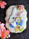 Glazed gingerbread as a white rabbit with clocks on a dark background