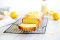 glazed lemon loaf cake sliced on a cooling rack with lemon zest Royalty Free Stock Photo