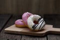 Glazed mini donuts on wooden background