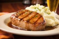 glazed pork chop on a bed of mashed potatoes Royalty Free Stock Photo