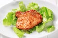 Glazed pork chop on lettuce leaves Royalty Free Stock Photo