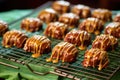 glazed pralines cooling on a wire rack