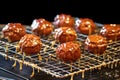 glazed pralines cooling on a wire rack