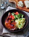 Glazed roasted chicken leg with mashed potatoes and vegetable salad on a wooden background Royalty Free Stock Photo