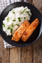 Glazed salmon fillet with rice garnish close-up. Vertical top vi Royalty Free Stock Photo