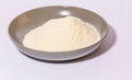 a glazed terracotta bowl containing wheat flour ready to be kneaded.