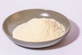 a glazed terracotta bowl containing wheat flour ready to be kneaded.