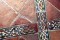 Glazed tiles of an ancient floor, crossed