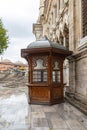 Glazed, wooden gazebo with carvings, near the wall of the mosque Royalty Free Stock Photo