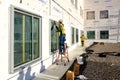 A glazier sealing newly installed windows. Royalty Free Stock Photo