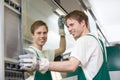 Glazier putting glass in grinding machine Royalty Free Stock Photo