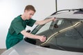 Glazier removing windshield