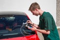 Glazier repairing windscreen after stone chipping damage