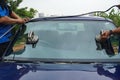 Glazier using tools repairing to fix crack broken windshield, wi