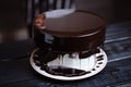 Glazing chocolate mousse cake, close-up Royalty Free Stock Photo