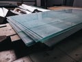 Glazing of a new office, insulation of window frames. A stack of glass sheets at a construction site, the material is glass for