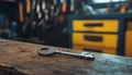 Gleaming silver key on rustic wooden counter in workshop setting with organized tools and key racks in the background Royalty Free Stock Photo