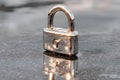 Shiny Silver Padlock on Reflective Surface for Security and Protection Themes Generative AI Royalty Free Stock Photo