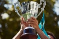 gleaming silver trophy being lifted by a winners hands Royalty Free Stock Photo