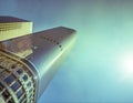 Gleaming skyscraper with bright sun blue sky background Royalty Free Stock Photo