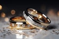 Gleaming wedding bands set against bokeh and diamond dust, text space