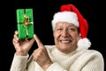 Gleeful Aged Man Pointing At Raised Green Present Royalty Free Stock Photo