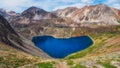 Glen mountain lake in the shape of a heart. Atmospheric green landscape with lake in high mountain flowers valley. Great scenery Royalty Free Stock Photo